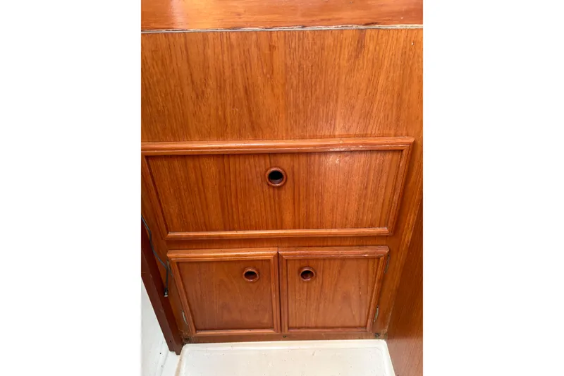 Slide: The Image of Wooden cabinet doors inside a 1988 Pearson 28 sailboat interior. - 23