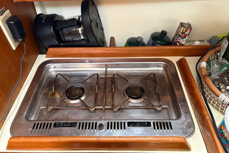Slide: The Image of Two-burner stove in a 1988 Pearson 28 boat galley, with kitchen appliances nearby. - 25