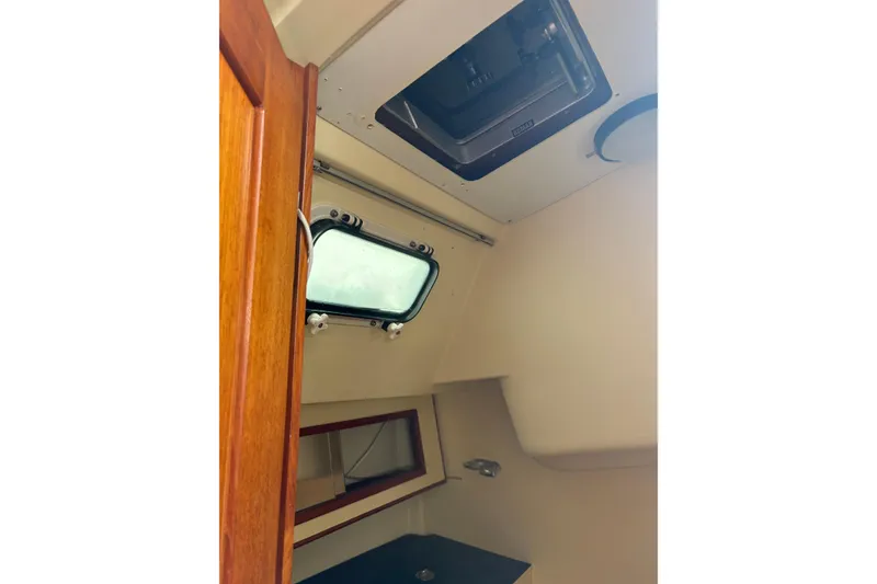 Slide: The Image of Interior cabin view of a 1988 Pearson 28 sailboat, featuring a window and hatch. - 32