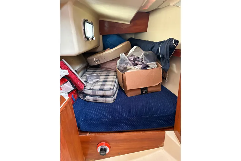 Slide: The Image of Interior of a 1988 Pearson 28 sailboat with cushions and storage items. - 33
