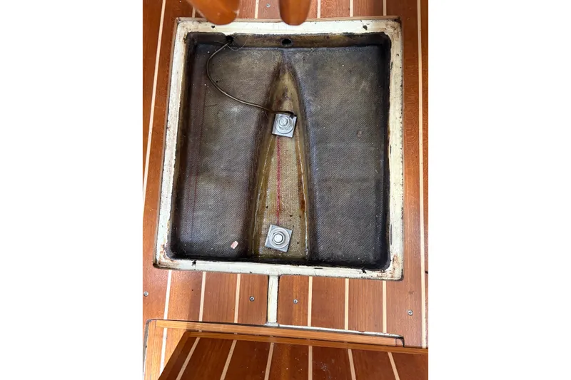Slide: The Image of Open hatch on 1988 Pearson 28 sailboat, revealing interior compartment and wiring. - 35