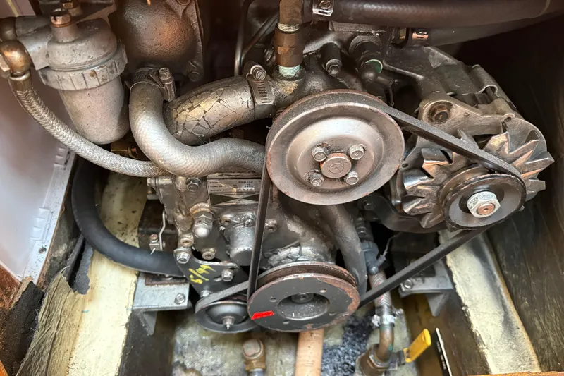 Slide: The Image of Engine compartment of a 1988 Pearson 28 sailboat, showing belts and hoses. - 38