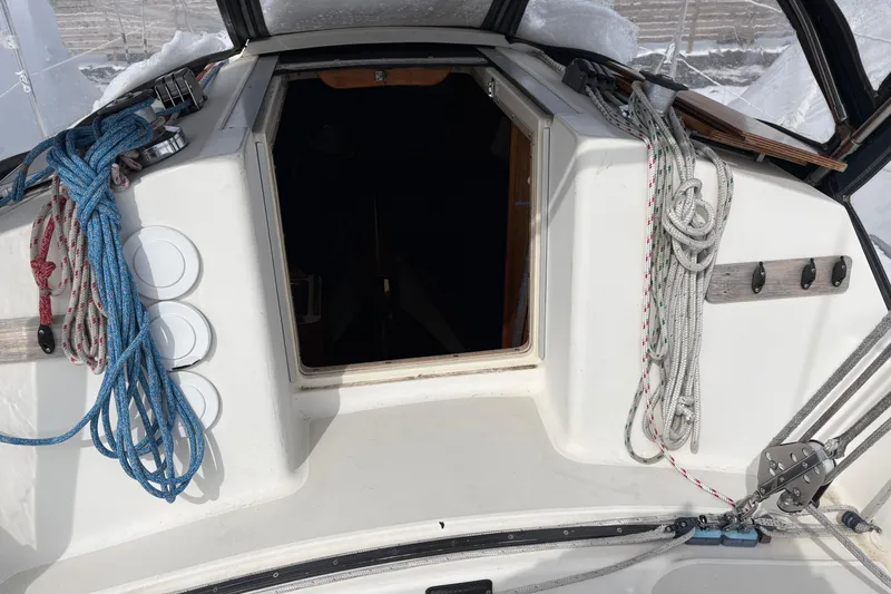Slide: The Image of Cockpit of 1988 Pearson 28 sailboat with ropes and open hatch. - 7