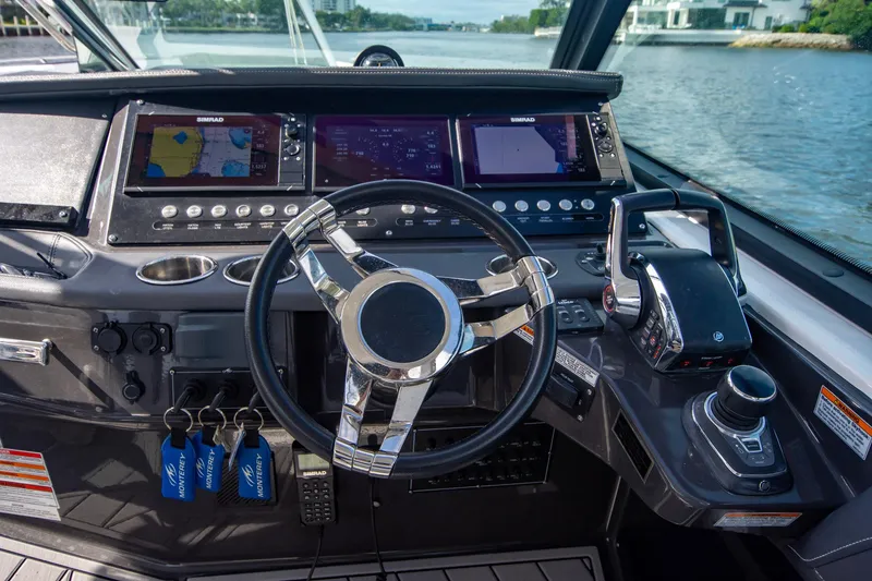 Slide: The Image of Cockpit of 2022 Monterey 385SS Super Sport boat with advanced navigation controls. - 10