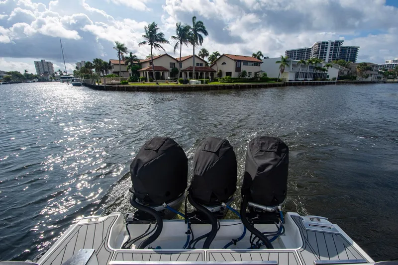 Slide: The Image of 2022 Monterey 385SS Super Sport boat with covered engines on a scenic waterfront. - 11