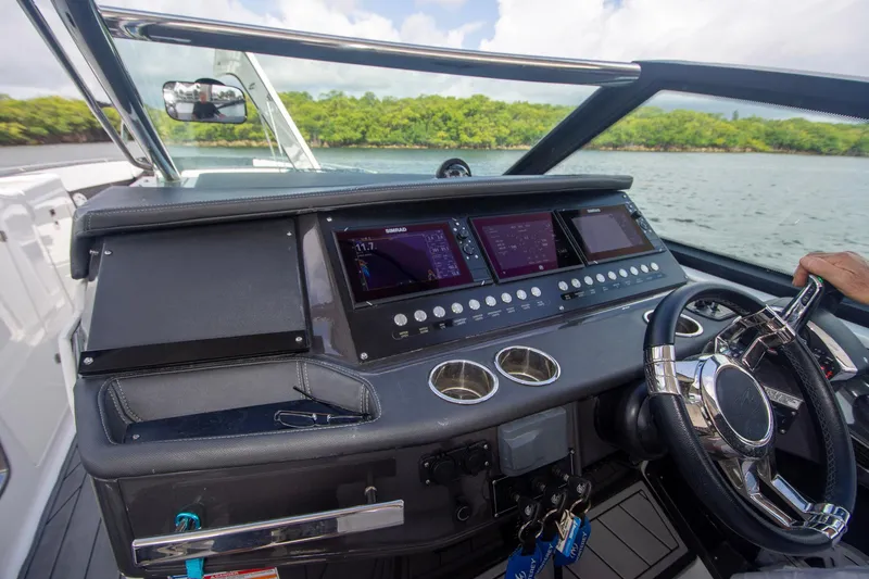 Slide: The Image of Cockpit of 2022 Monterey 385SS Super Sport boat with advanced navigation controls and steering wheel. - 12
