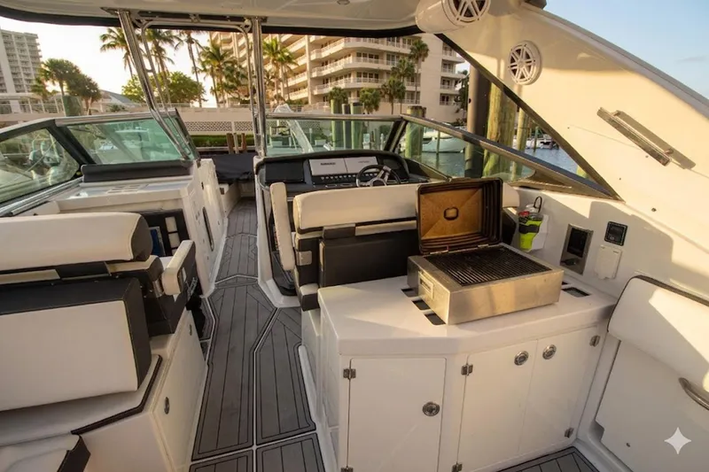 Slide: The Image of Luxurious 2022 Monterey 385SS Super Sport boat interior with grill and seating area. - 17