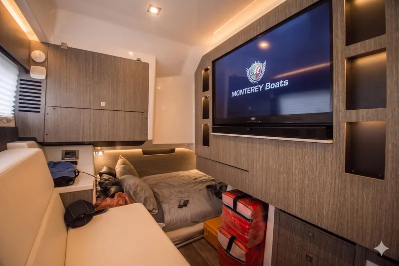 Slide: The Image of Luxurious interior of 2022 Monterey 385SS Super Sport boat with TV and cozy seating area. - 23