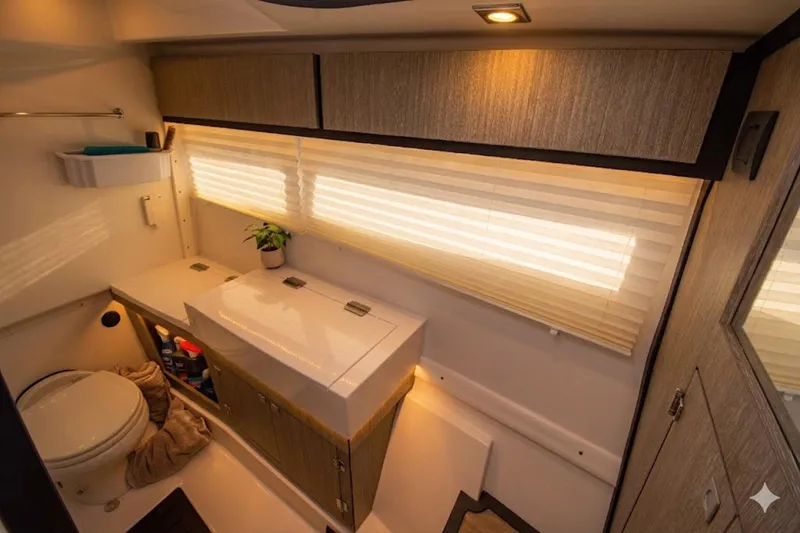 Slide: The Image of Luxurious bathroom interior of 2022 Monterey 385SS Super Sport boat, featuring modern fixtures and cabinetry. - 24