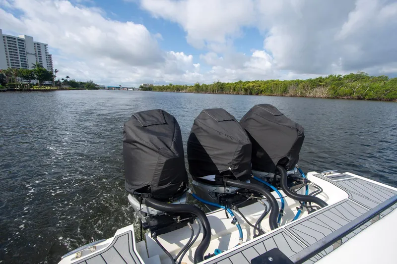 Slide: The Image of 2022 Monterey 385SS Super Sport boat with covered engines on a scenic waterway. - 26