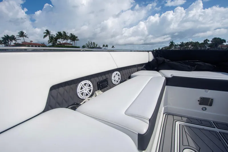 Slide: The Image of Luxurious seating on 2022 Monterey 385SS Super Sport boat with speakers, under a cloudy sky. - 31