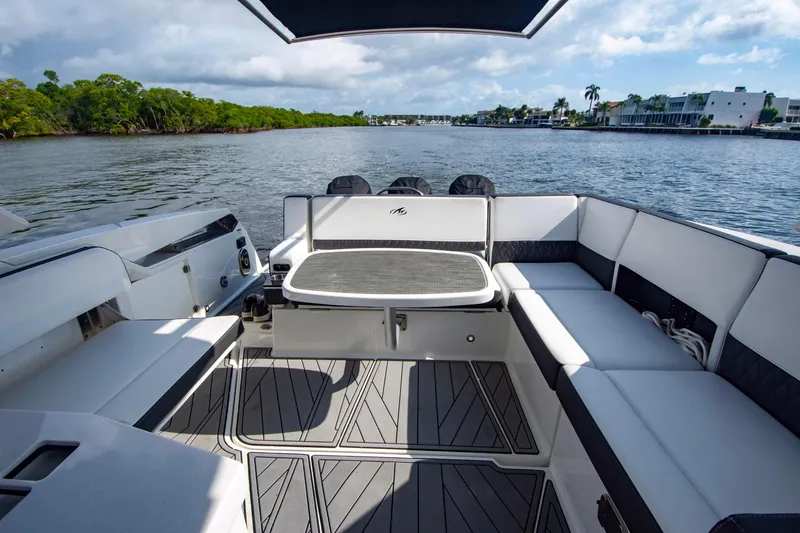 Slide: The Image of 2022 Monterey 385SS Super Sport boat interior with sleek seating and scenic water view. - 36