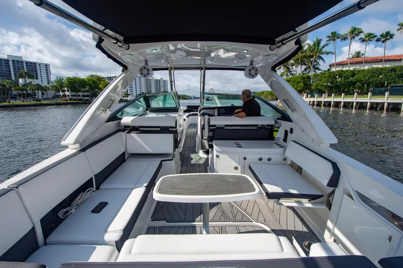 Slide: The Image of 2022 Monterey 385SS Super Sport luxury boat interior with seating and helm on a sunny day. - 44
