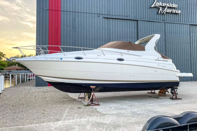 Slide: The Image of 1998 Cruisers Yachts 2870 Rogue at Lakeside Marina, displayed on stands. - 3