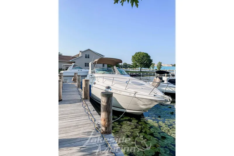 Slide: The Image of 1998 Cruisers Yachts 2870 Rogue docked at a marina with clear skies. - 4