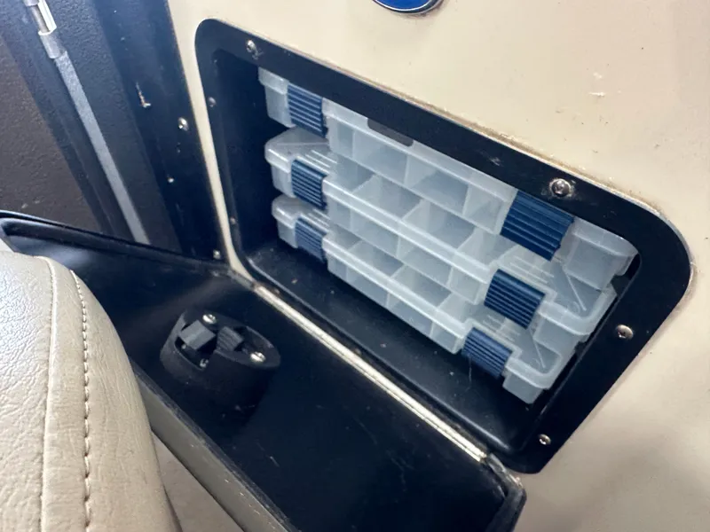 Slide: The Image of Storage compartment with plastic containers on Premier 241 Cast A Way boat. - 20