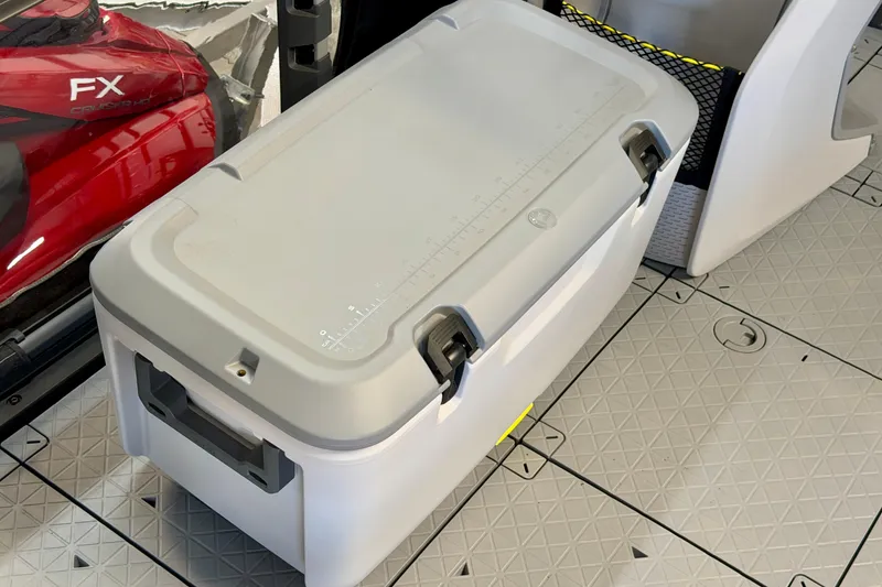 Slide: The Image of Cooler on 2026 Sea-Doo Switch Fish 21 deck, featuring textured flooring and nearby red watercraft. - 12
