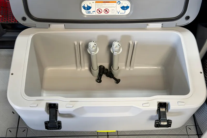 Slide: The Image of Open storage compartment of 2026 Sea-Doo Switch Fish 21, featuring secure latches and interior fittings. - 13
