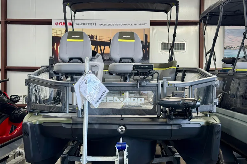 Slide: The Image of 2026 Sea-Doo Switch Fish 21 pontoon boat displayed indoors, featuring dual seats and advanced controls. - 4