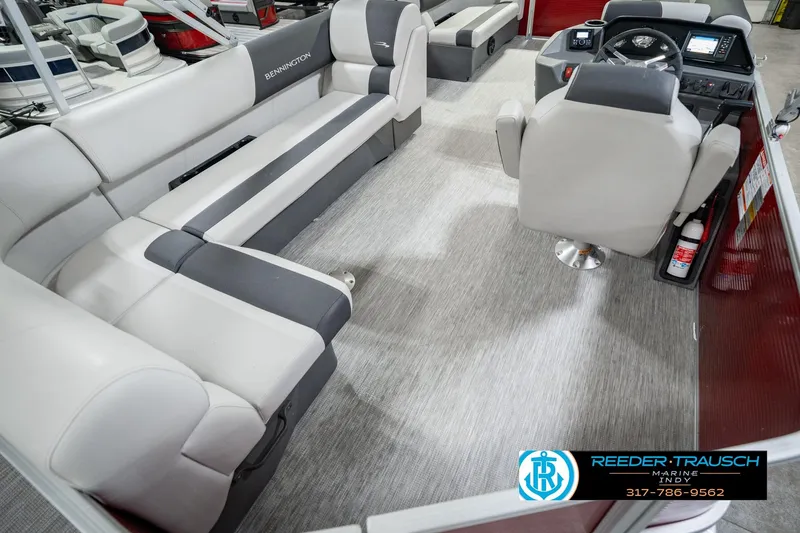 Slide: The Image of 2025 Bennington 20 SLS pontoon boat interior with plush seating and modern dashboard. - 17