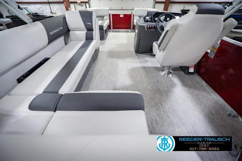 Slide: The Image of 2025 Bennington 20 SLS pontoon boat interior with modern seating and steering console. - 23