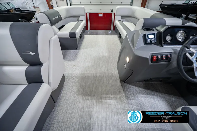 Slide: The Image of 2025 Bennington 20 SLS pontoon boat interior with plush seating and modern dashboard. - 25