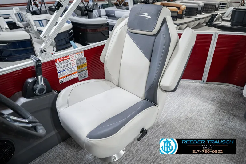 Slide: The Image of 2025 Bennington 20 SLS boat seat with gray and white upholstery in showroom setting. - 29