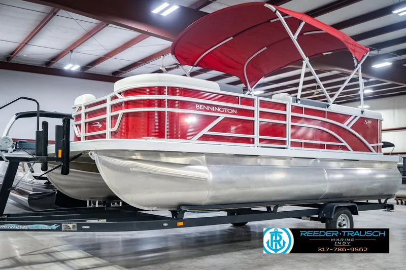 Slide: The Image of 2025 Bennington 20 SLS pontoon boat with red canopy on trailer in showroom. - 3
