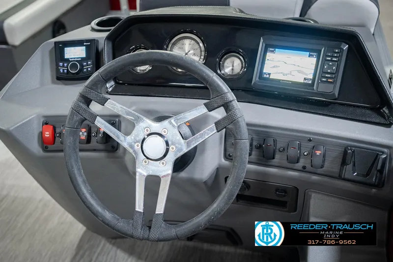 Slide: The Image of 2025 Bennington 20 SLS boat dashboard with steering wheel, gauges, and navigation system. - 38