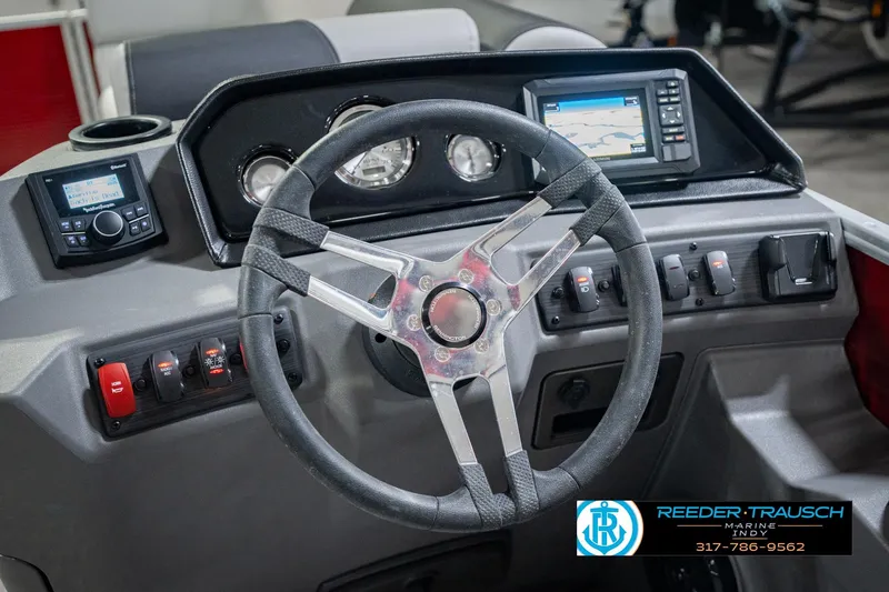 Slide: The Image of 2025 Bennington 20 SLS boat dashboard with steering wheel and control panel. - 39