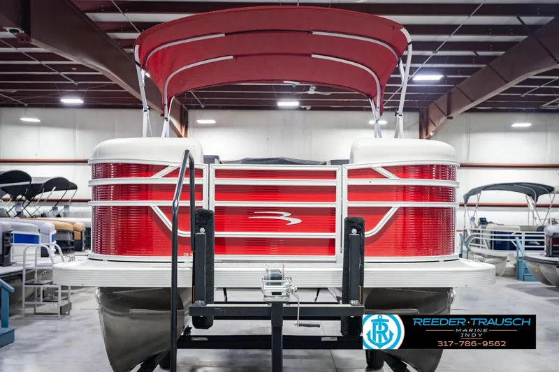 Slide: The Image of 2025 Bennington 20 SLS pontoon boat with red exterior in a showroom. - 5