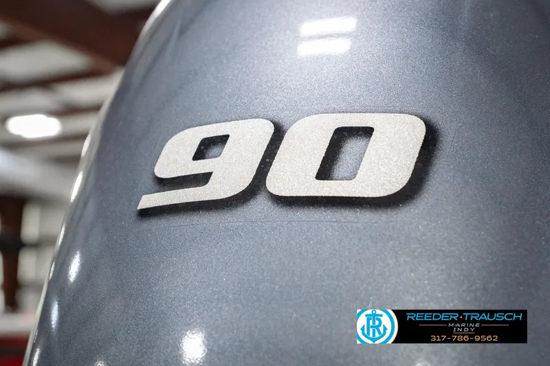 Slide: The Image of Close-up of 2025 Bennington 20 SLS boat engine with '90' decal, Reeder-Trausch Marine logo visible. - 57