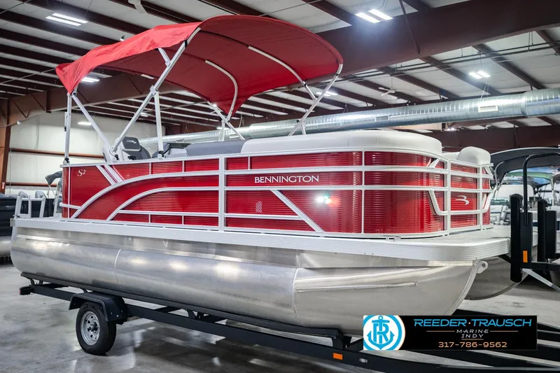 Slide: The Image of 2025 Bennington 20 SLS pontoon boat with red canopy in showroom. - 6
