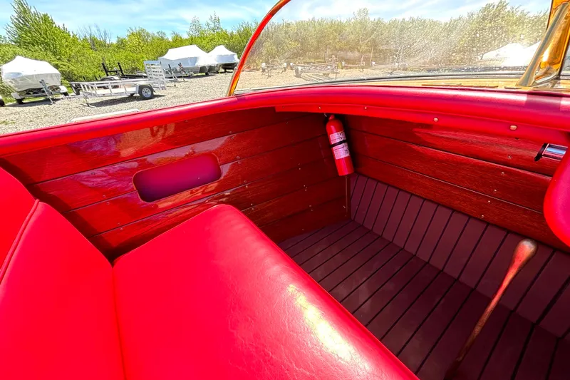 Slide: The Image of Interior of a 1956 Chris-Craft Capri 21 boat with red leather seats and wooden paneling. - 20