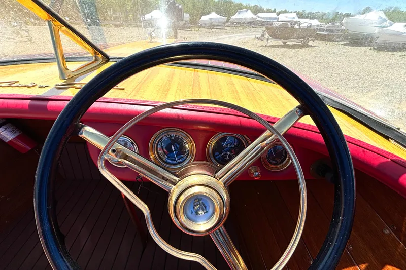 Slide: The Image of 1956 Chris-Craft Capri 21 dashboard with vintage steering wheel and gauges. - 22