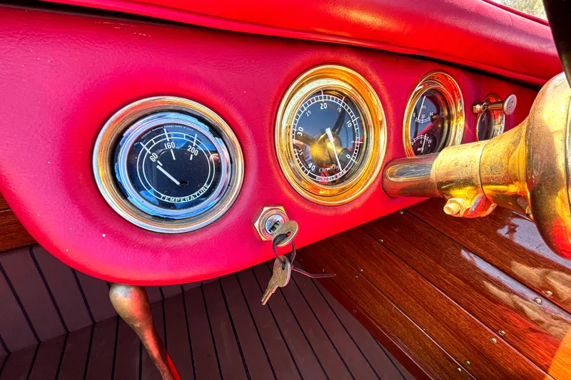Slide: The Image of 1956 Chris-Craft Capri 21 dashboard with vintage gauges and wooden accents. - 23