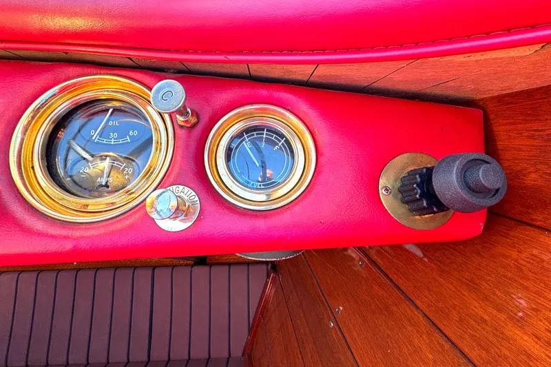 Slide: The Image of 1956 Chris-Craft Capri 21 dashboard with vintage gauges and red leather trim. - 24