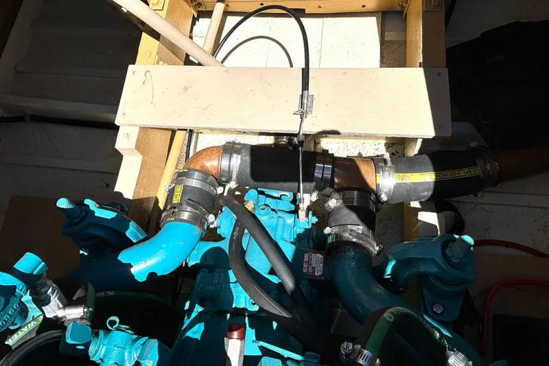 Slide: The Image of Engine compartment of a 1956 Chris-Craft Capri 21 boat, showcasing blue engine components. - 29