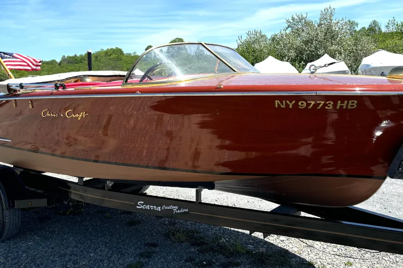 Slide: The Image of 1956 Chris-Craft Capri 21 boat propeller and rudder on gravel surface. - 33
