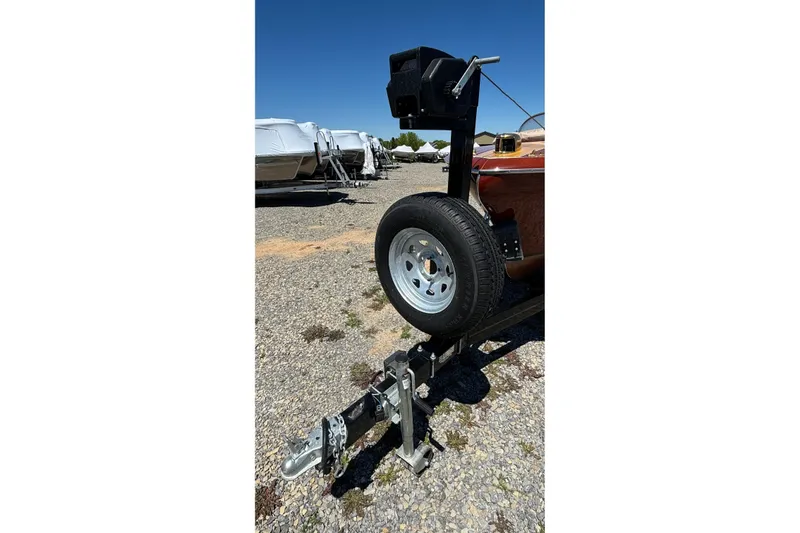 Slide: The Image of 1956 Chris-Craft Capri 21 boat trailer with spare tire on gravel lot. - 34