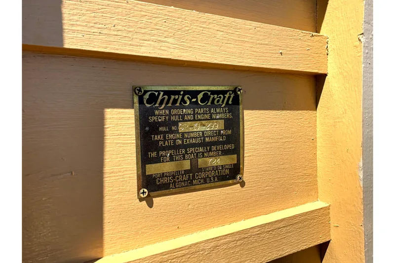 Slide: The Image of 1956 Chris-Craft Capri 21 identification plate on wooden surface, displaying hull and engine details. - 40