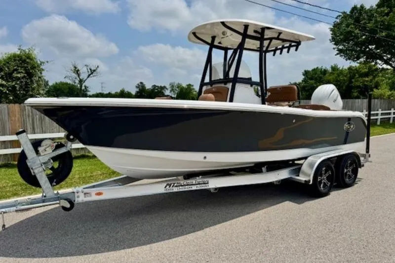 The Image of 2026 Sea Hunt Ultra 219 boat on trailer, side view. - 1