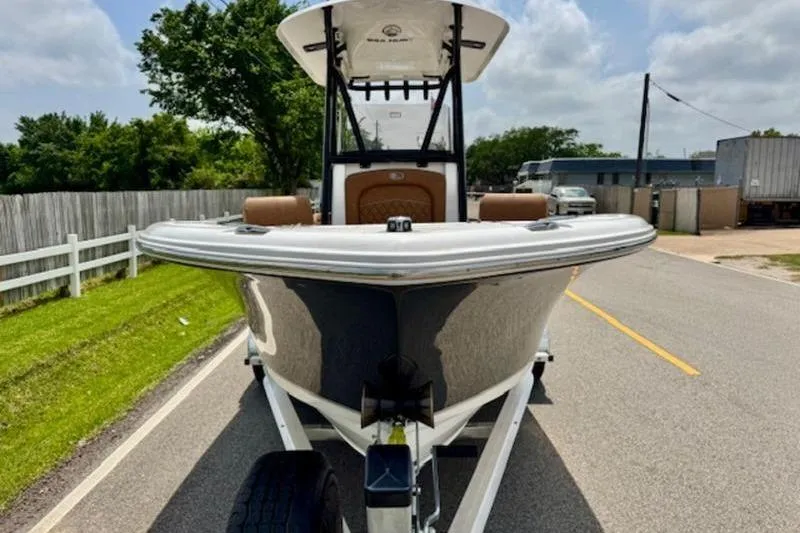 Slide: The Image of 2026 Sea Hunt Ultra 219 boat on trailer, road in background. - 6