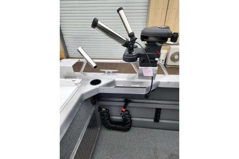 Slide: The Image of 2025 Thunder Jet 21 Chinook OS boat interior with rod holders and motor detail. - 13