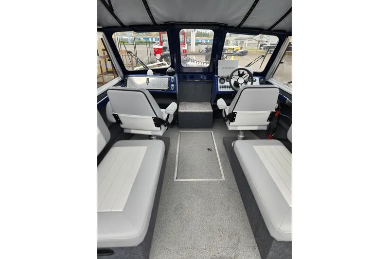 Slide: The Image of Interior of 2025 Thunder Jet 21 Chinook OS boat with seating and control panel. - 16