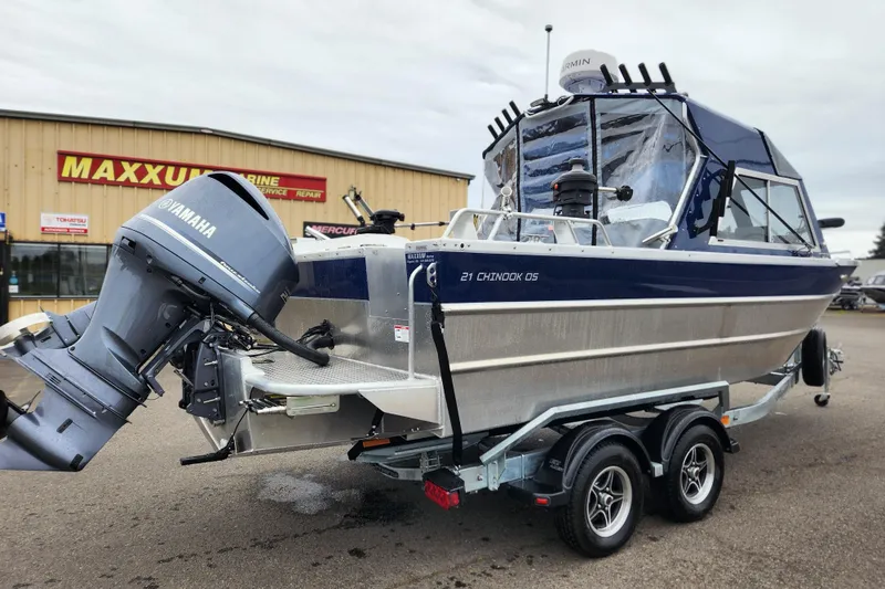 Slide: The Image of 2025 Thunder Jet 21 Chinook OS boat with Yamaha engine on trailer, parked outside Maxxum Marine. - 2