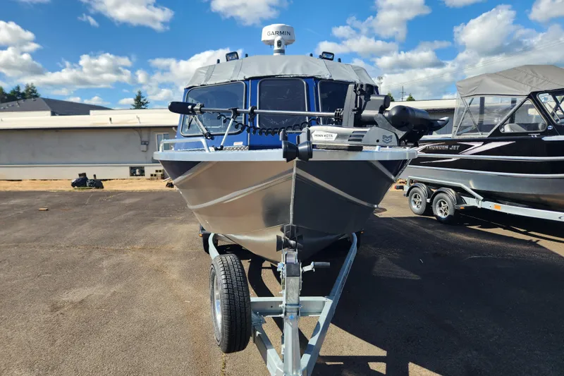 Slide: The Image of 2025 Thunder Jet 21 Chinook OS boat on trailer under blue sky. - 26