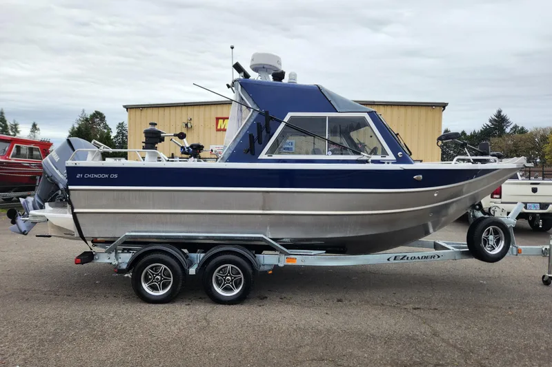 Slide: The Image of 2025 Thunder Jet 21 Chinook OS boat on trailer, parked outdoors. - 6