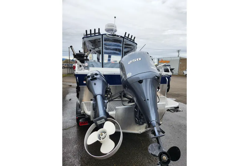 Slide: The Image of 2025 Thunder Jet 21 Chinook OS boat with dual outboard motors, parked outdoors. - 9