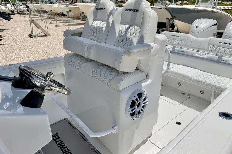 Slide: The Image of Luxurious 2025 Bluewater 25t boat interior with plush seating and modern steering wheel. - 11